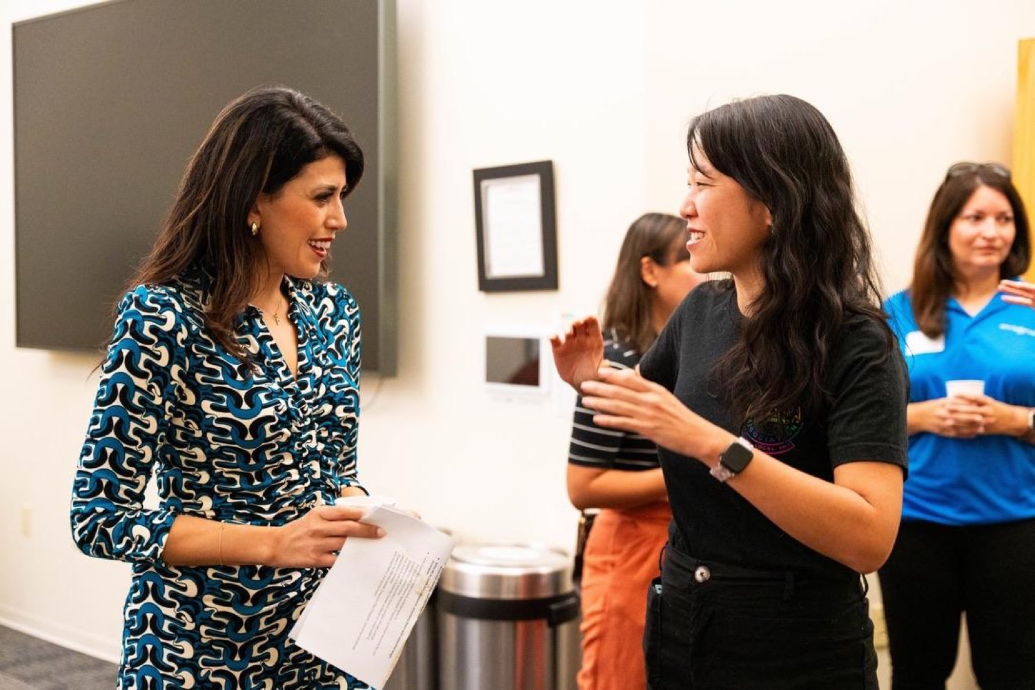 Selena talking with a community member